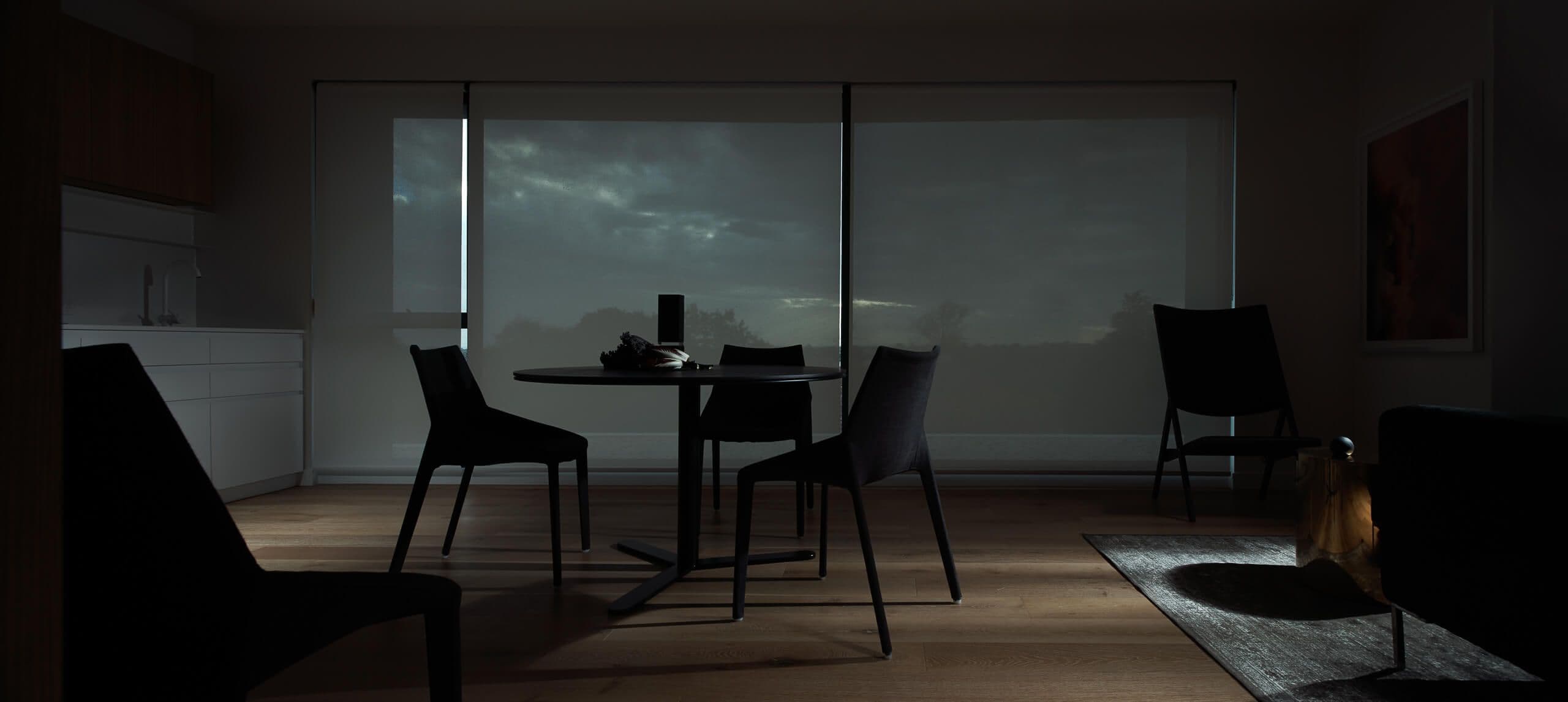Dining room in dark tones, greys, with blue touches. moody