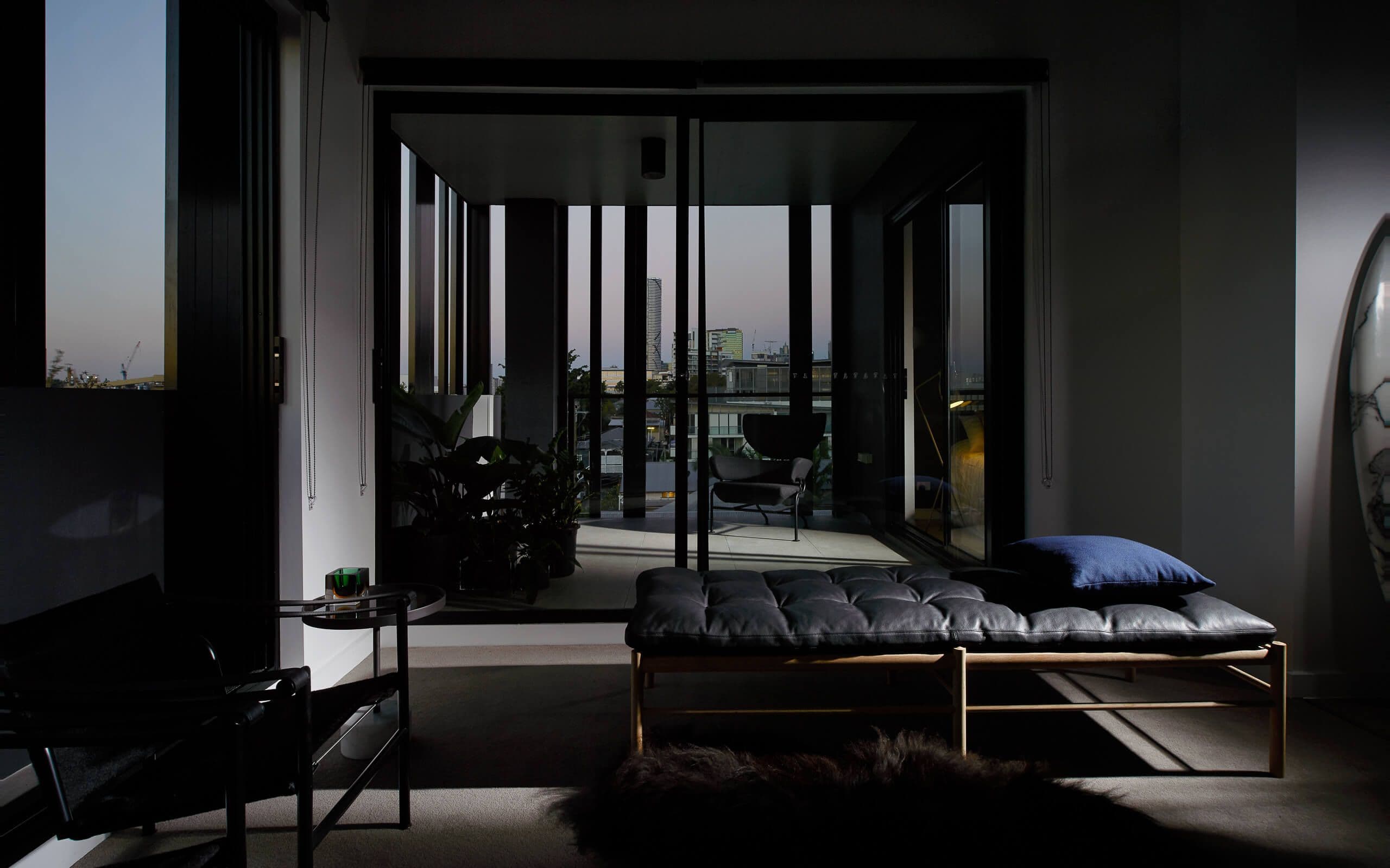 Chase lounge in front of mirrors in dark tones