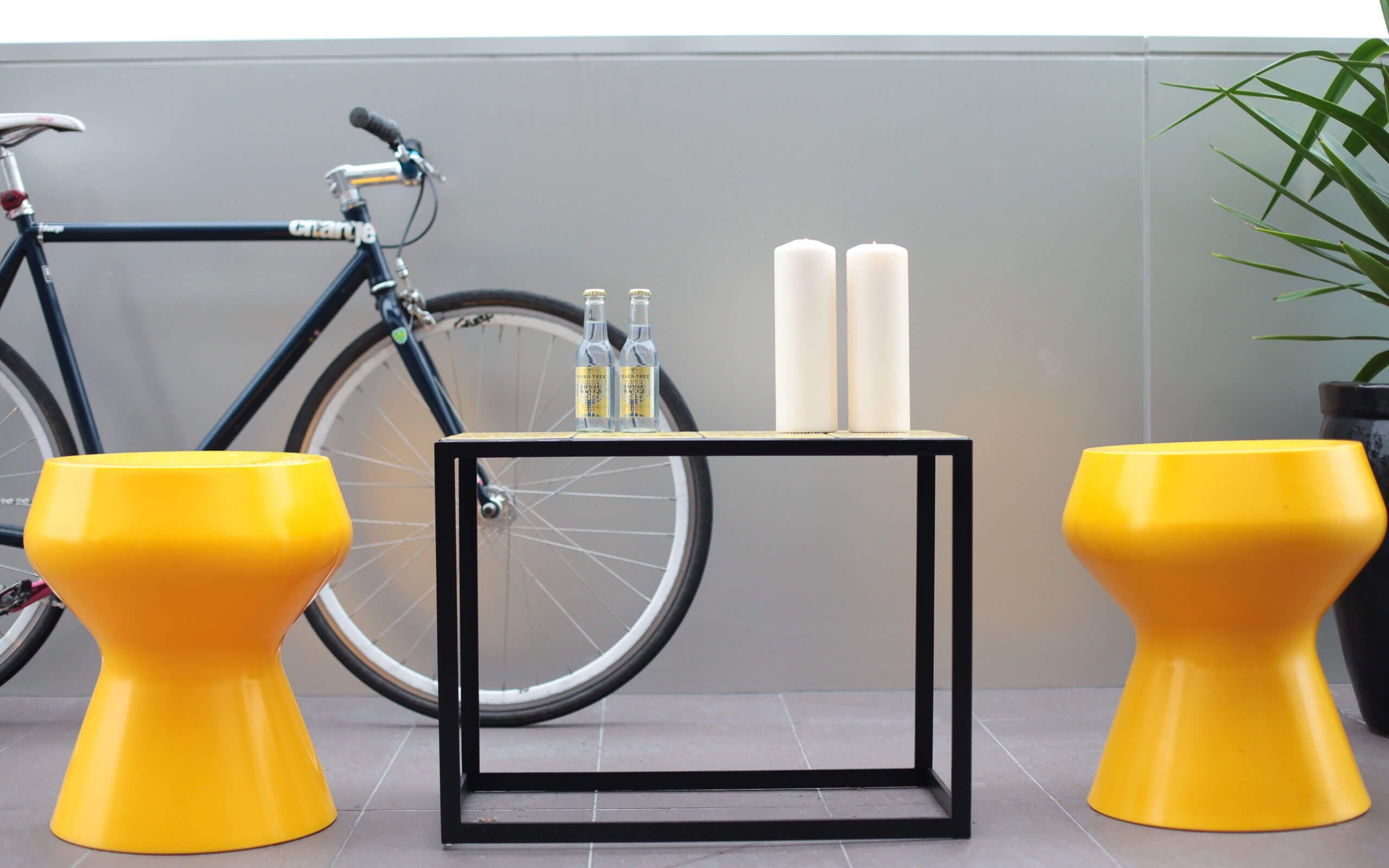 Yellow stools by outdoor table