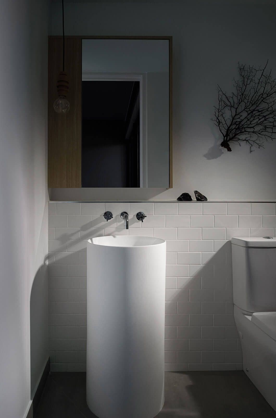 Dark tones curated shot of a ensuite sink in white