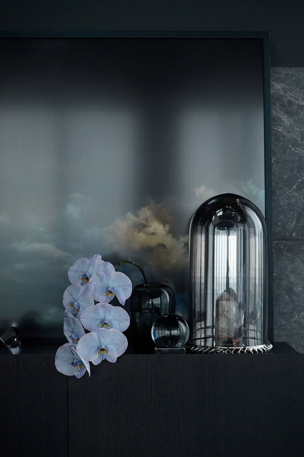 White and glass items on a dark shelf