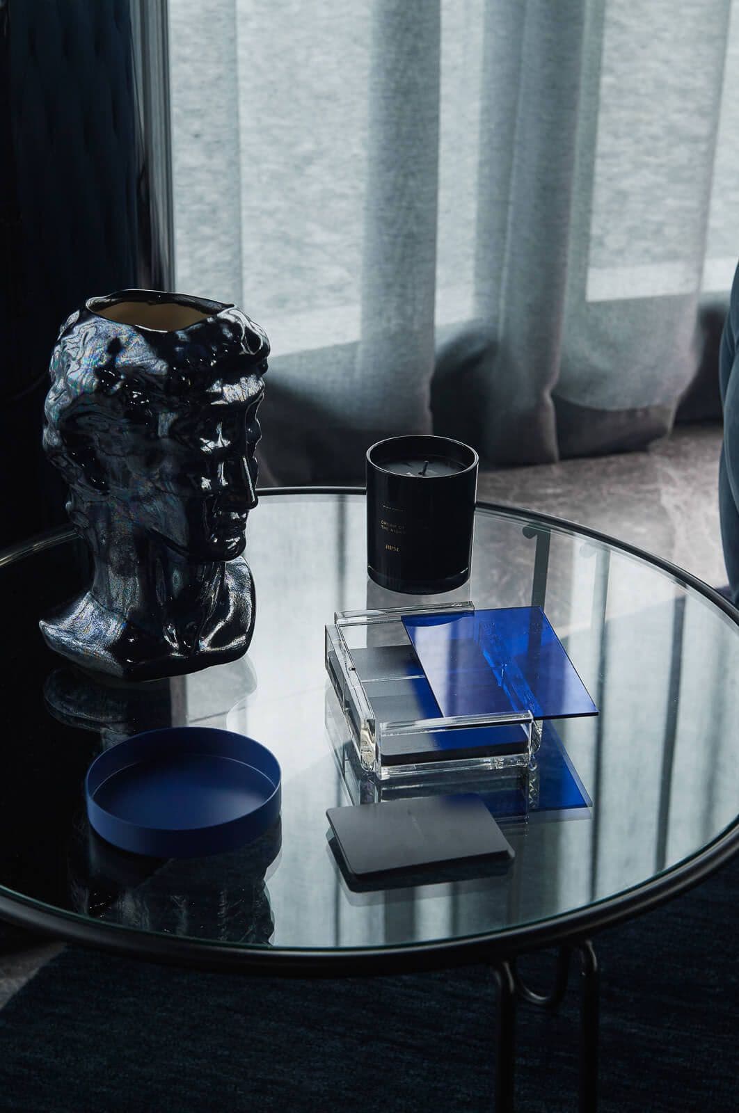 Blue and grey items on a glass table