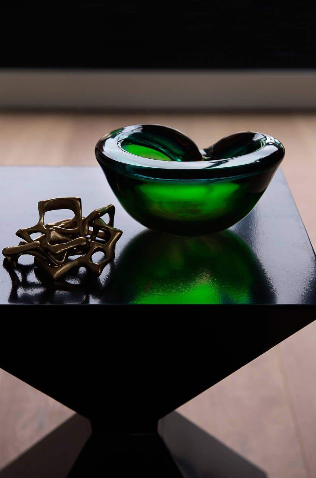 Gladd items on a side table with strong shadows and highlights