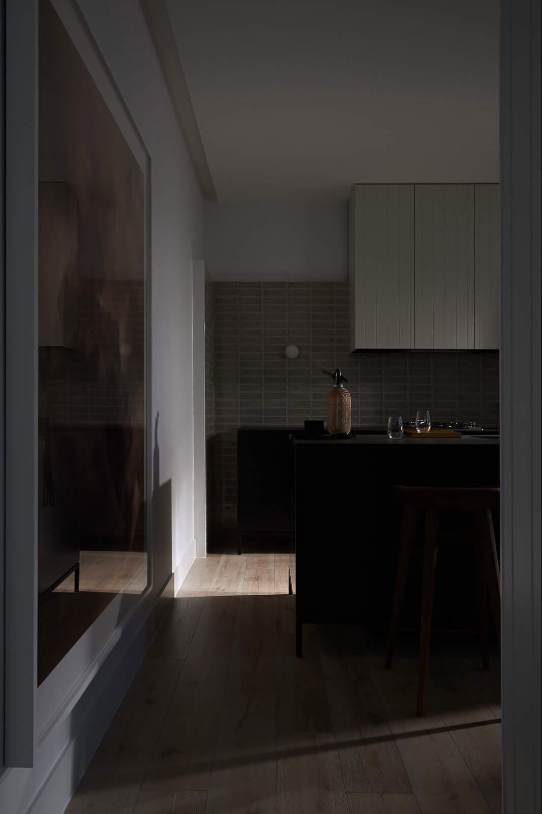 Dark lit view from coridoor to kitchen