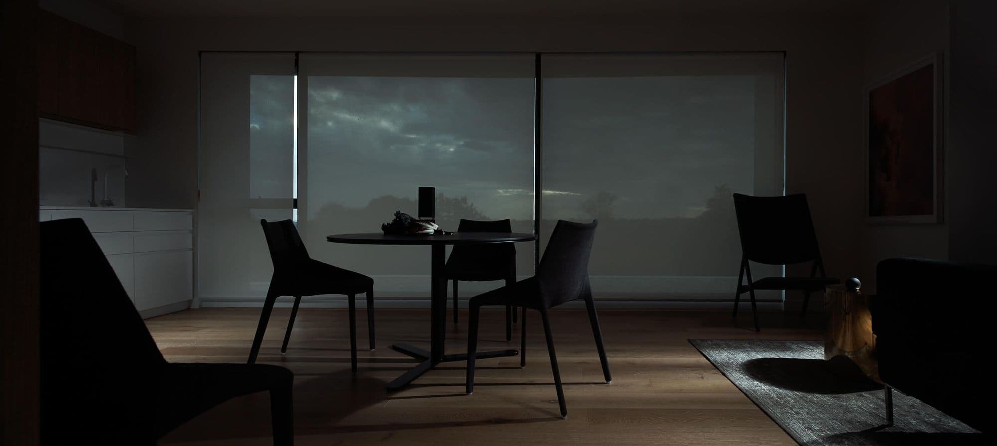 Dining room in dark tones, greys, with blue touches. moody